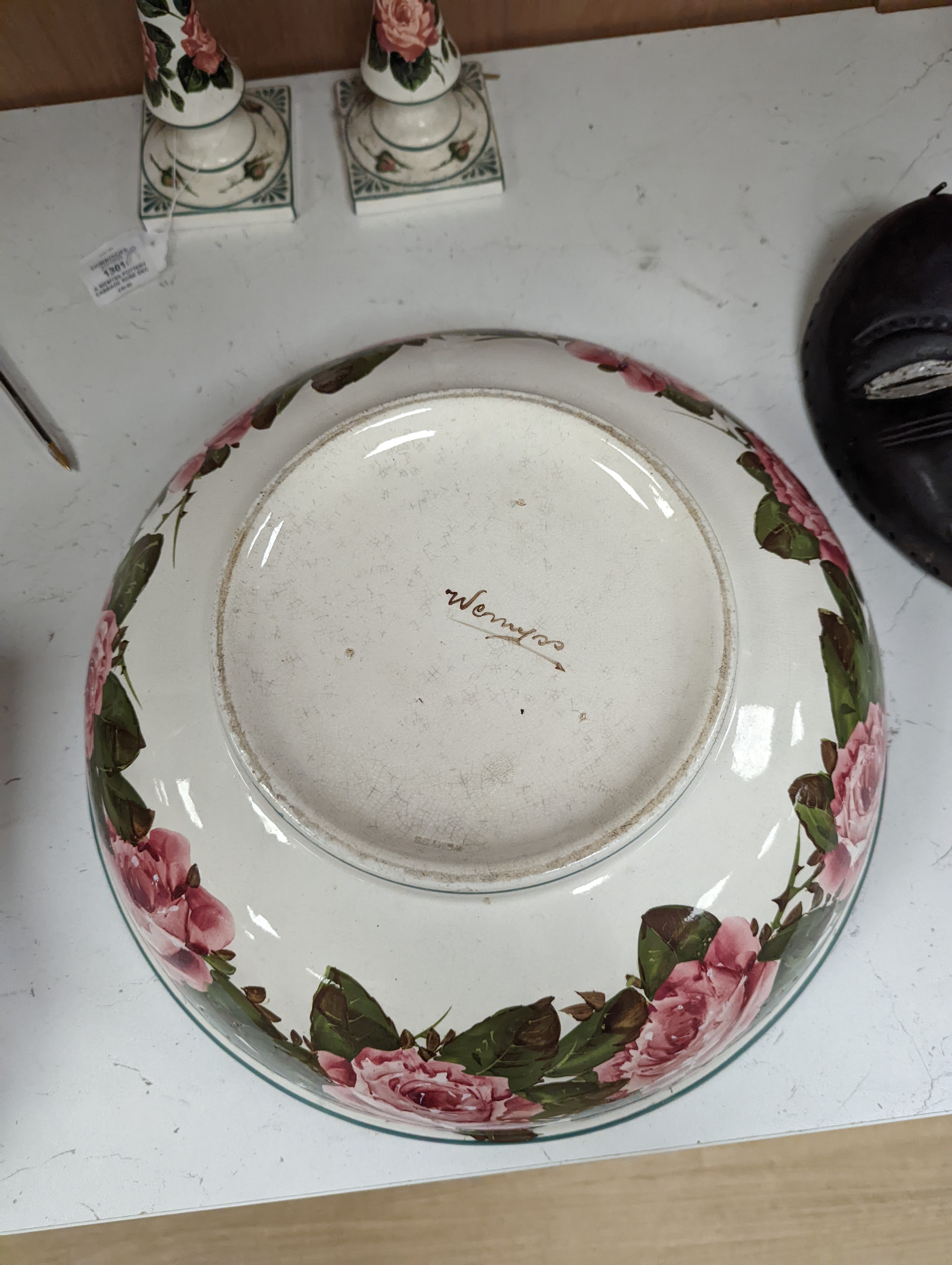 A Wemyss pottery Cabbage rose decorated toilet bowl, diameter 39cm, and a pair of Weymss style candlesticks by Griselda Hill pottery